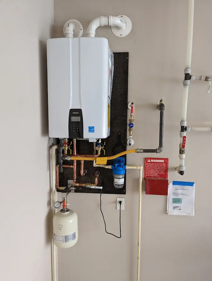 Professional plumber installing copper piping in a Cleveland home